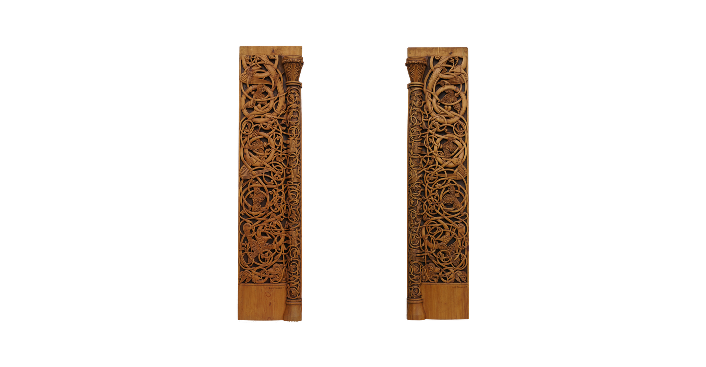 Two tall pine planks carved clean through with interlaced tendrils and beasts, a slender half-column and capital running down the inner edge of each.