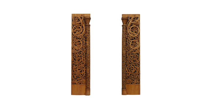 Two tall pine planks carved clean through with interlaced tendrils and beasts, a slender half-column and capital running down the inner edge of each.