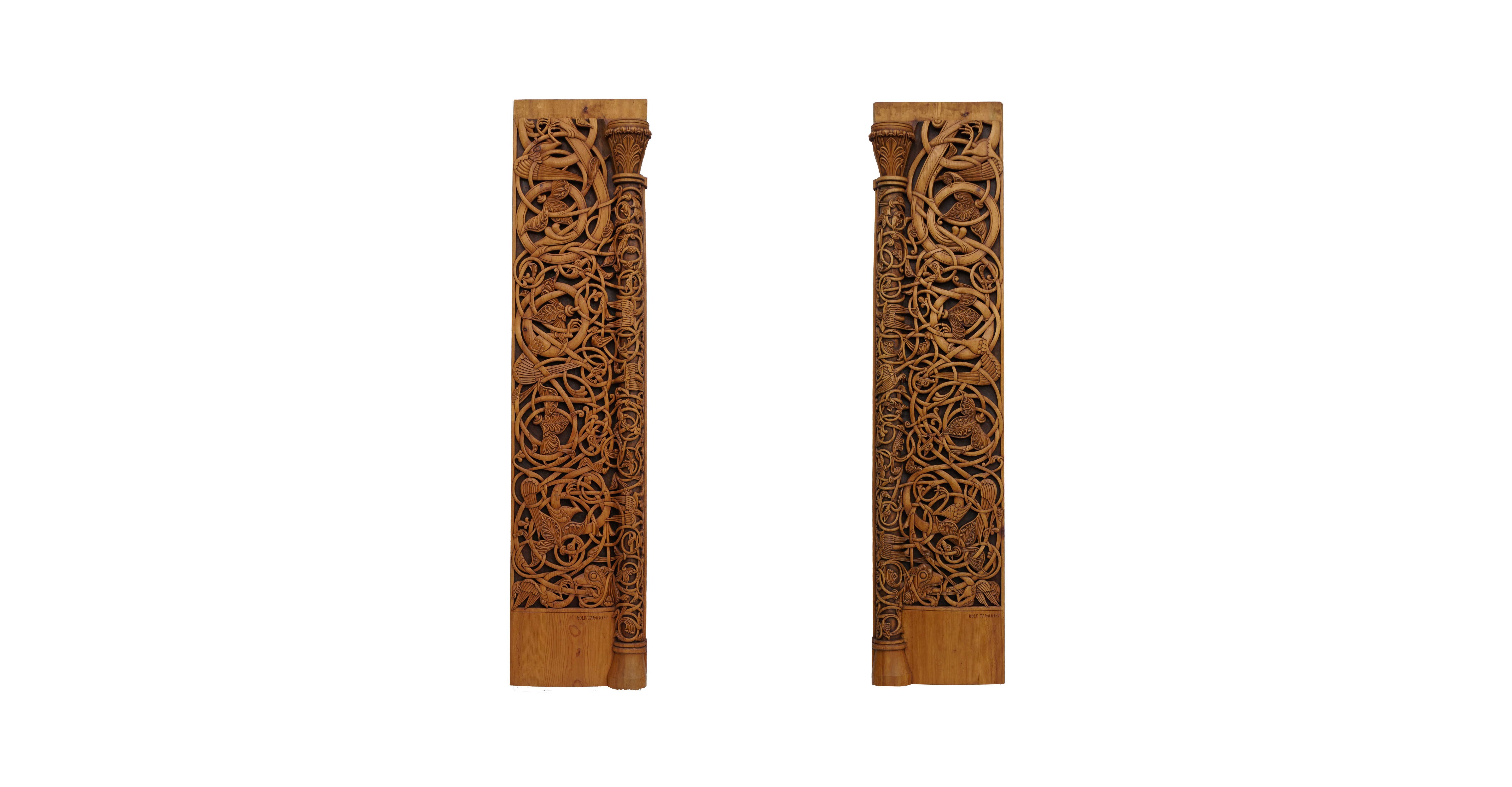 Two tall pine planks carved clean through with interlaced tendrils and beasts, a slender half-column and capital running down the inner edge of each.